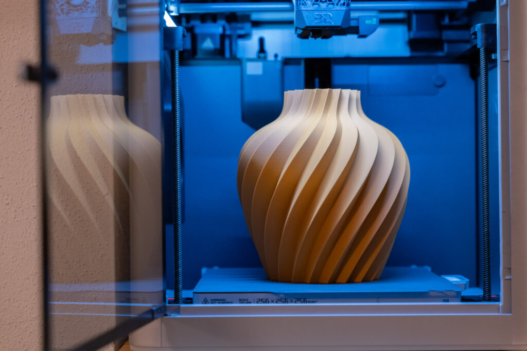 3D-gedruckte Vase mit eleganten, gedrehten Kurven in warmem Sandton auf mydesignstyle.com. Moderne Technologie trifft Stil.