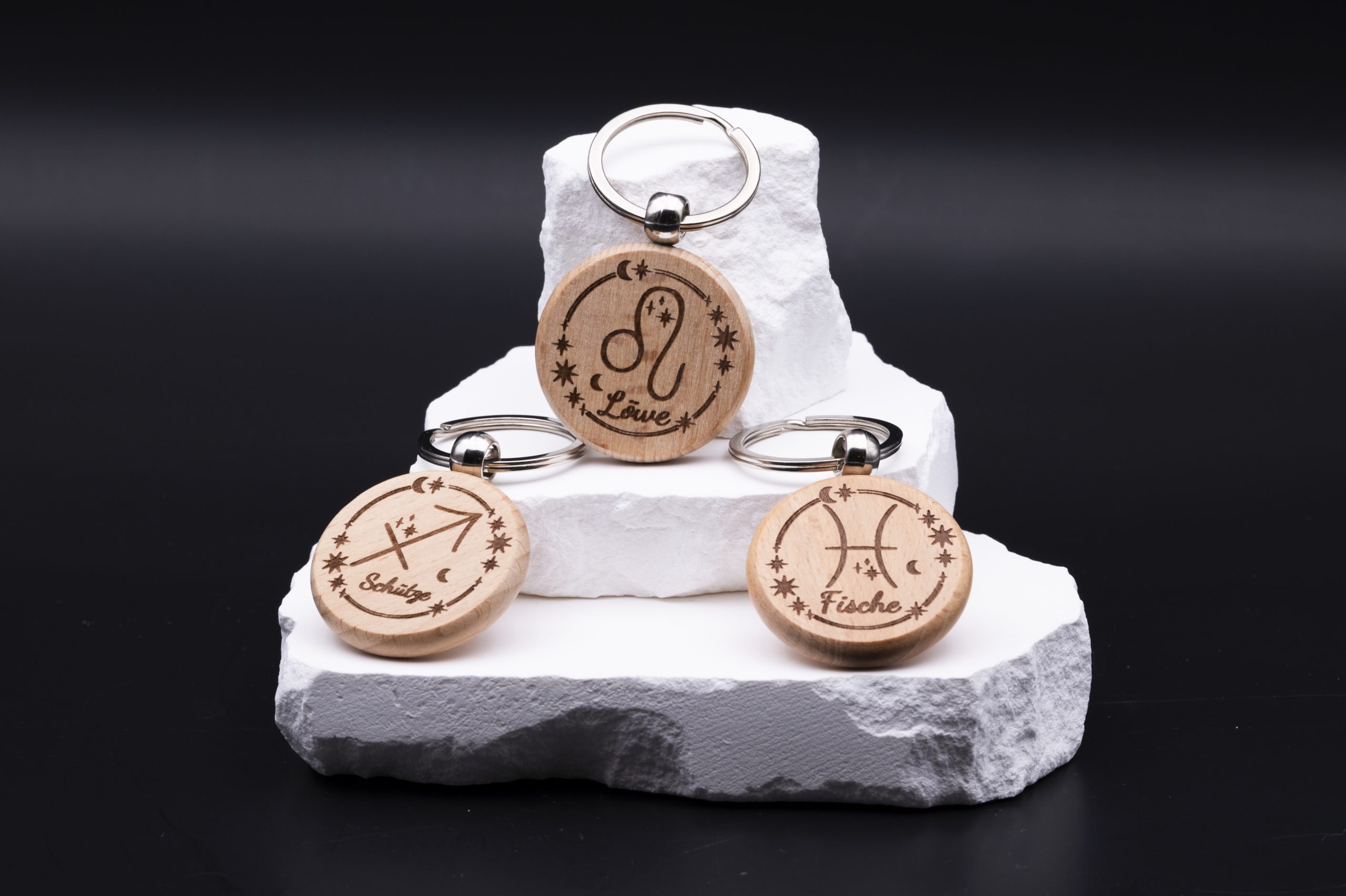 Runder Schlüsselanhänger aus Holz mit Sternzeichen-Gravur